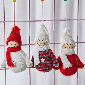Three felt Christmas angel ornaments with knitted hats and wooden stars hanging on a grid