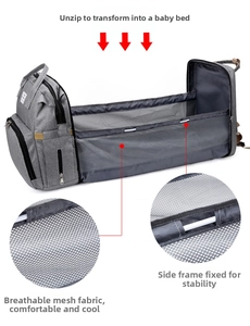 Detail of gray folding diaper bag expanding into a travel bassinet with mesh sides
