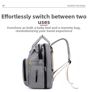 Macro detail of waterproof grey Oxford fabric and reinforced handle on multifunctional diaper bag