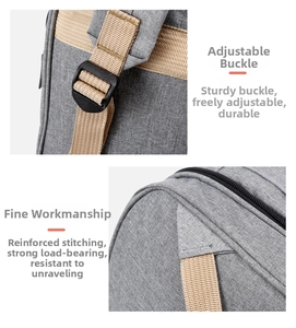 Detail view of adjustable plastic buckle and reinforced stitching on gray diaper bag