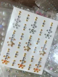 Detail of rhinestone and pearl sticker sheet for facial and eye makeup decoration