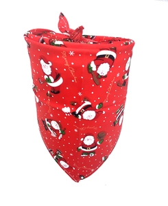 Detail of red cotton Christmas dog bandana featuring Santa Claus patterns and snowflakes