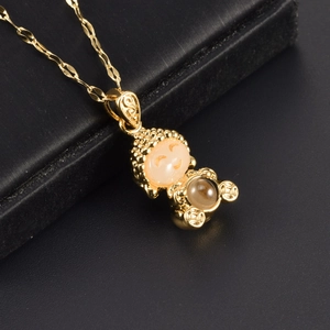 Golden Laughing Buddha necklace with orange beads and ancient coin pendant detail