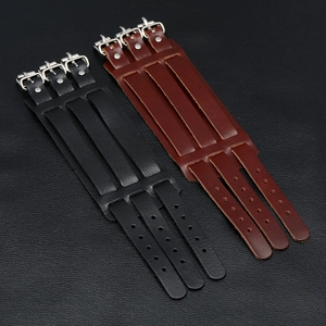Detail view of adjustable black and brown wide leather punk cuffs with triple metal buckles