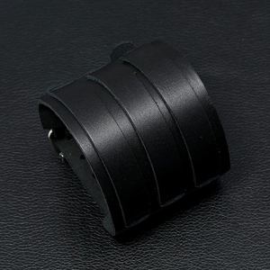 Macro detail of multilayer woven black leather motorcycle punk bracelet for men