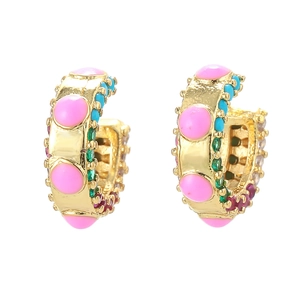Kleurrijke boheemse gouden oorringen met roze en turquoise stenen op een witte basis
