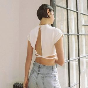 Women's white crop top featuring a trendy backless design with crisscross tie-up details