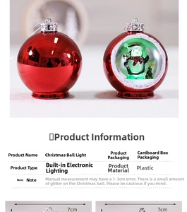 Detail of 7cm glowing Christmas balls with a cute penguin inside and mirror finish