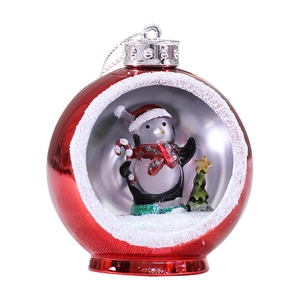 Red Christmas ball ornament with LED light and penguin scene inside a transparent window