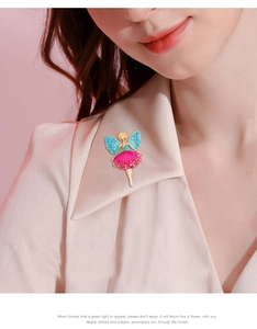 Detail of ballet dancer brooch with pink crystals on model's light-colored clothing