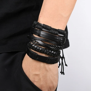Close-up of men's multi-layer black leather woven bracelets on a model's wrist