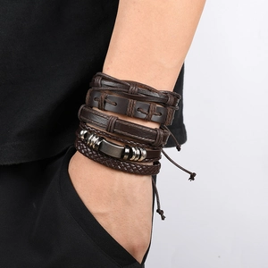Set of five brown multilayer braided leather bracelets for men and women on a wrist