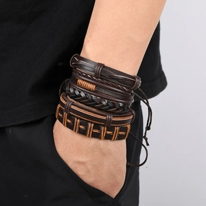 Close-up of vintage multi-layer braided leather bracelets in black and brown on a male wrist