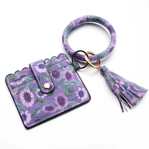 Detail view of purple floral PU leather card holder set with gold ring and tassel