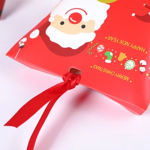 Red Christmas pillow gift boxes with Santa prints and red satin ribbons for holiday treats