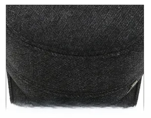 Detailed macro view showing the precise suture technique on the wool flat top cap crown