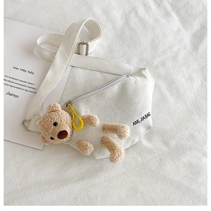 Detail of white canvas chest bag with 3D plush bear and yellow zipper puller