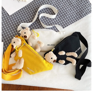 Detailed close-up of three canvas chest bags with 3D teddy bears in yellow, white, and black