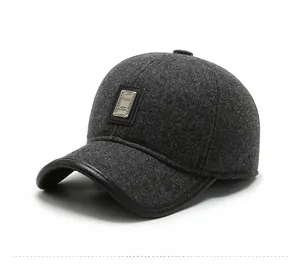 Detail of dark gray wool baseball cap with classic metal plaque and leather trim edge
