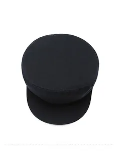 Top view of a black cotton newsboy cap showing durable twill fabric and stitching