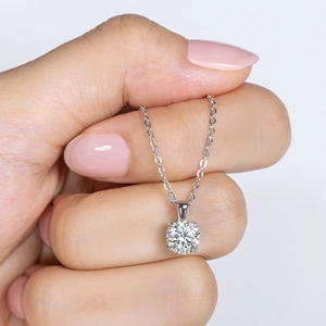 Close-up of a 925 sterling silver necklace with a 1 carat round moissanite pendant