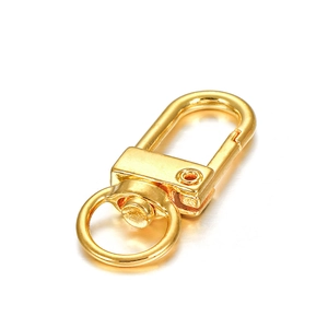 Macro shot of polished gold-plated lobster clasp swivel hook for DIY keychain crafts