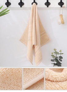 Macro detail of beige thick cotton towel showing dense terry loops and soft texture