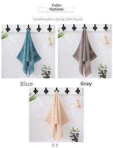 Detailed texture of thick cotton towels in blue, gray and beige with gold trim