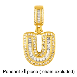 Macro detail of gold-plated hip-hop letter U pendant with cubic zirconia stones
