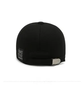 Detail view of adjustable metal buckle and TUC TIC woven label on thick wool baseball cap