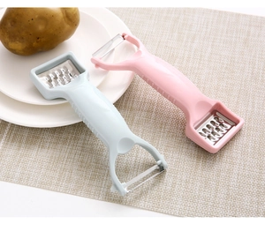 Close-up of pink and blue dual-head kitchen peelers and graters for fruits and potatoes