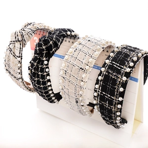 Detail of tweed pearl knotted headbands in black and white check pattern for women