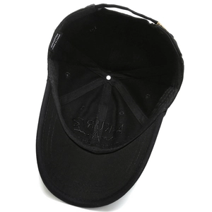 Internal view of black cotton baseball cap showing quality stitching and 100% cotton label