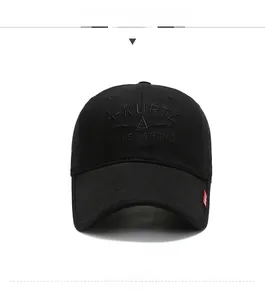 Detailed close-up of a black baseball cap featuring 3D embroidery and red side label