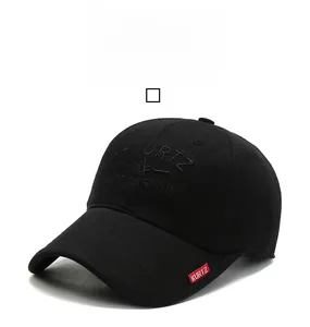 Detail of A-KURTZ embroidery and red woven label on black twill cotton baseball cap