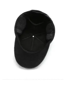 Detail of wool blend winter cap featuring thick black lining and foldable ear flaps