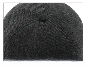 Detailed view of strict cap suture technique on gray wool baseball cap crown