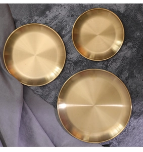 Three-piece set of brushed gold circular storage trays with fine metallic texture