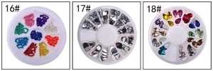 Detailed view of assorted nail art rhinestones in heart, teardrop, and bead shapes