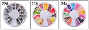 Macro detail of mixed nail art charms in a 12-slot circular container box