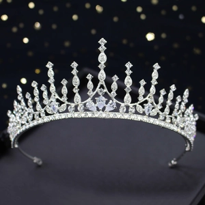 Elegant silver crown tiara with sparkling crystal rhinestones on luxury black background
