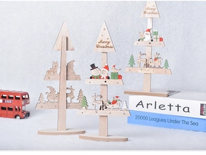 Detailed view of layered wooden Christmas tree ornaments with Merry Christmas engraving