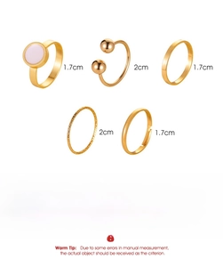 Detailed view of 5-piece gold alloy ring set featuring star and moon motifs and sizing info