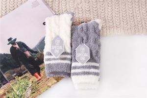 Detail of soft striped coral fleece sleep socks in grey and white for winter comfort