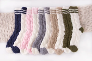 Close-up of fluffy striped coral fleece socks in multiple colors for winter warmth