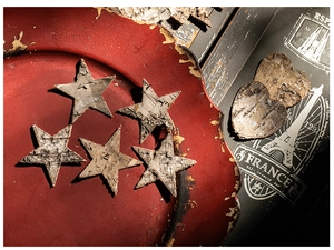 Macro detail of natural birch bark star and heart ornaments on a vintage tray
