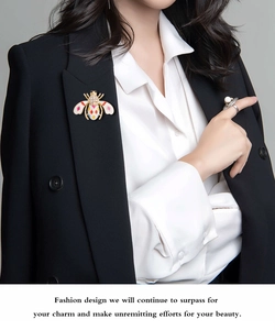 Close-up of a colorful enamel bee brooch with rhinestones on a black blazer