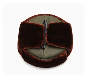 Detailed top view of olive green trapper hat with warm faux fur lining and ear flaps
