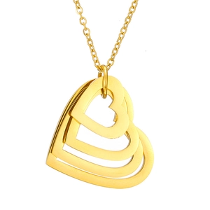 Detail of a gold triple-layer heart pendant necklace with smooth metallic finish