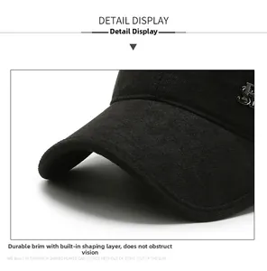 Detail of black baseball cap showing sturdy brim and metallic S ornament on cotton fabric